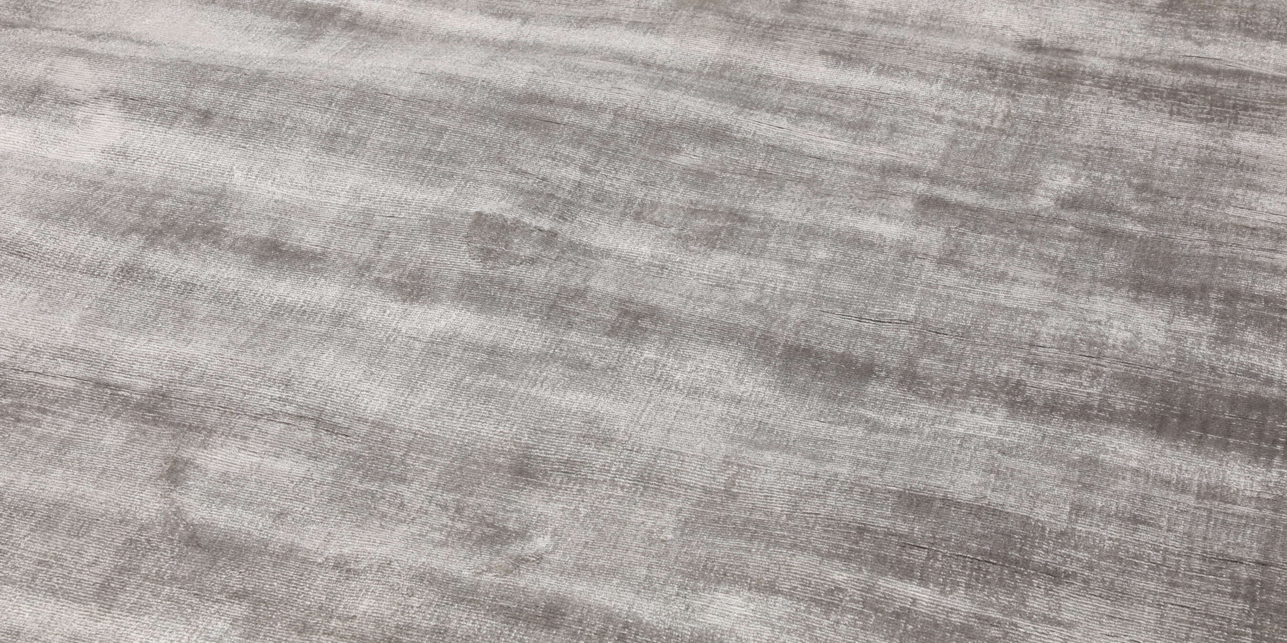 Close-up of a grey silky viscose rug texture