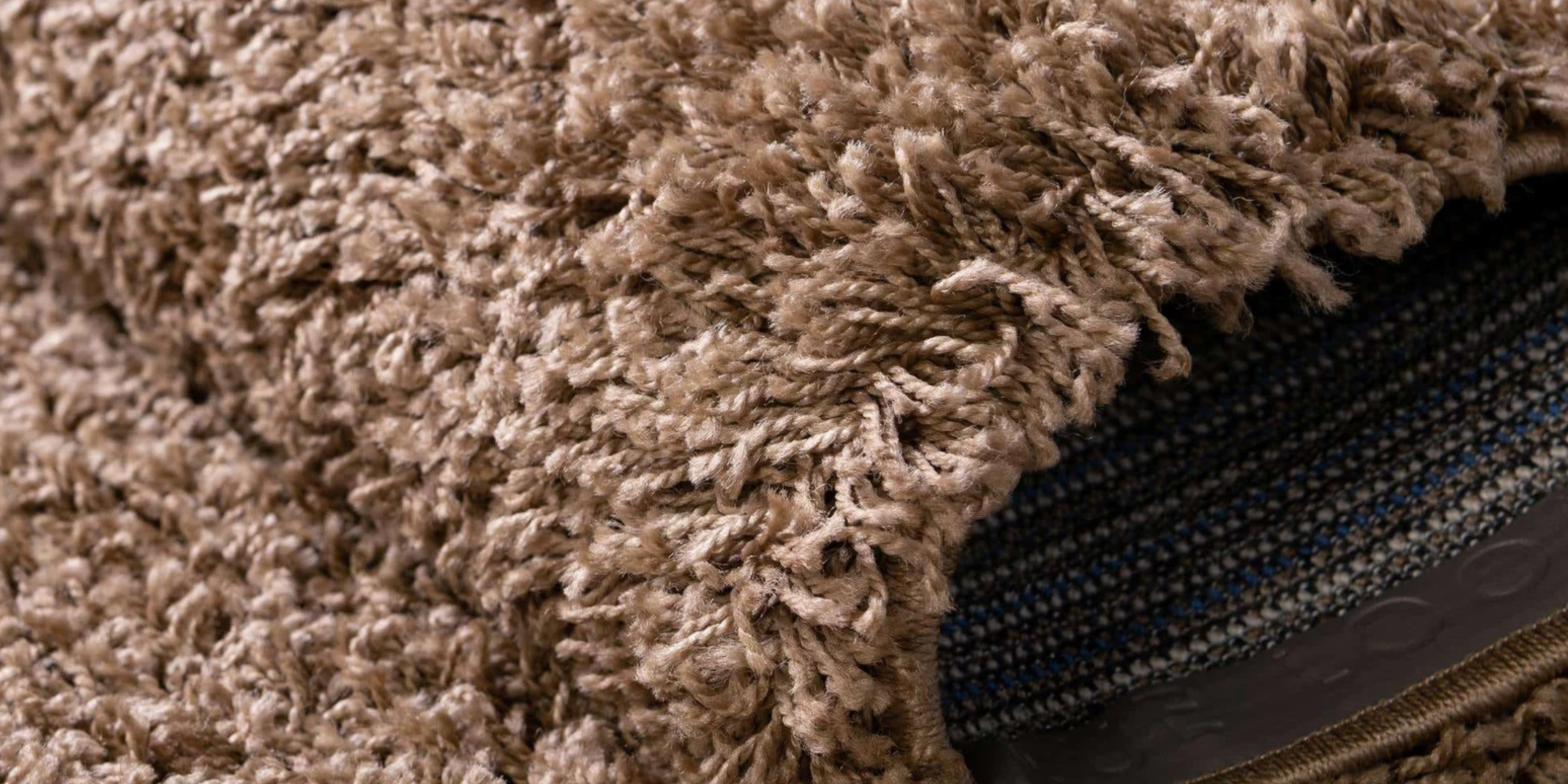 Close-up of a brown shaggy rug texture