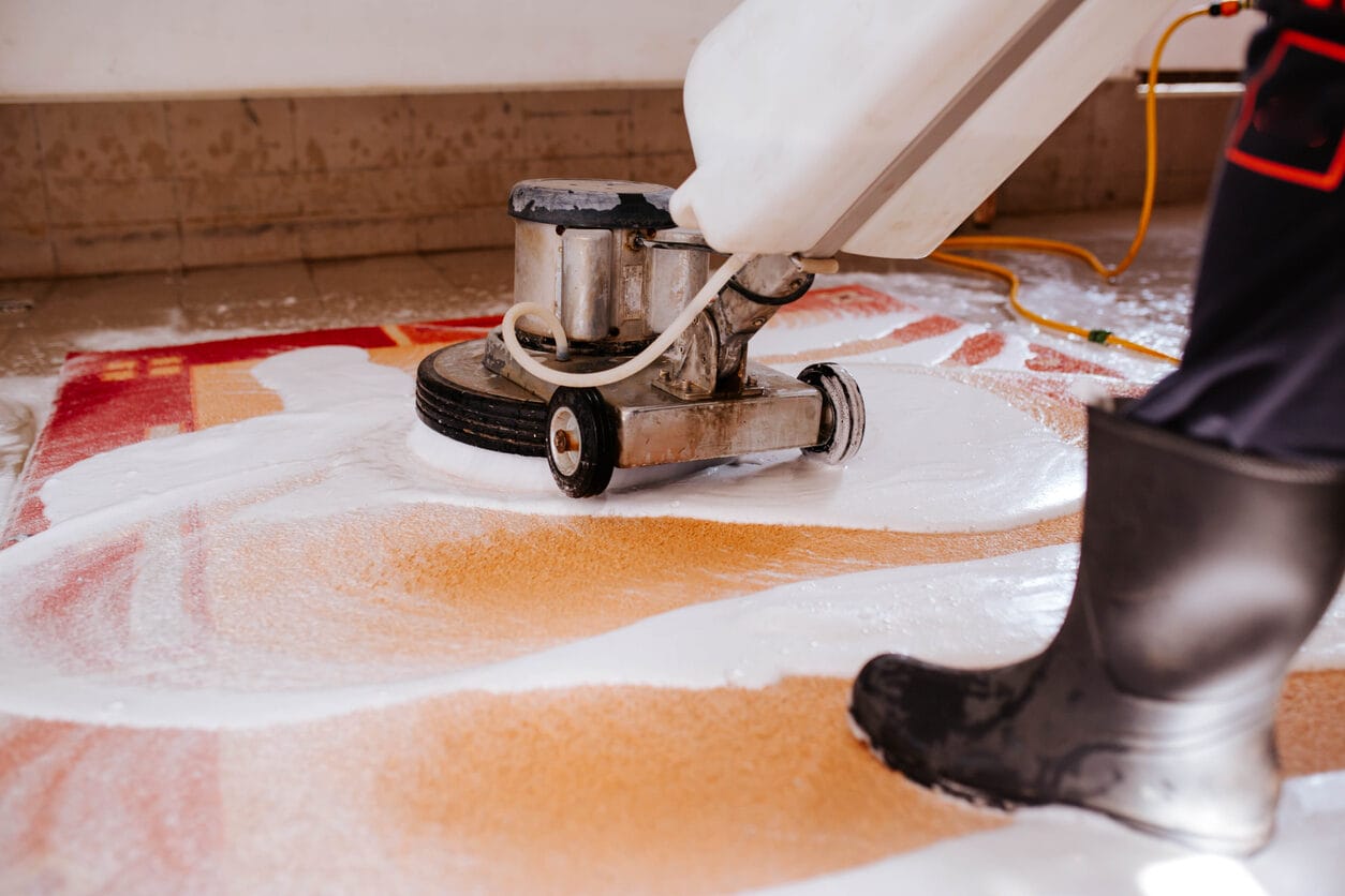 Hand washing a rug on the wash floor at the Premier Rug Cleaning Yatala facility