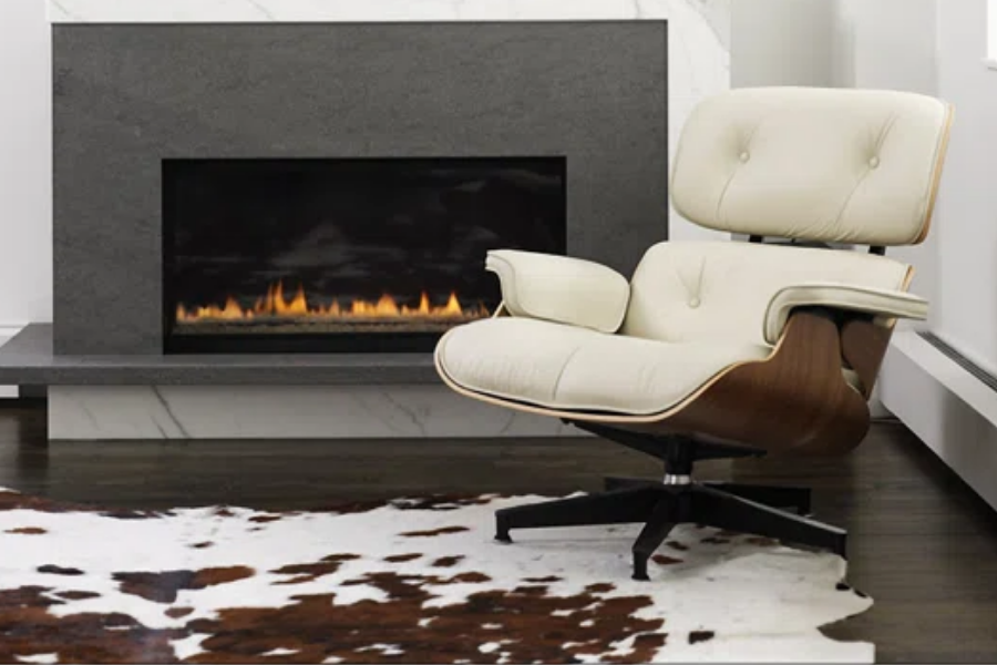 Brown and white cowhide rug in front of a fireplace