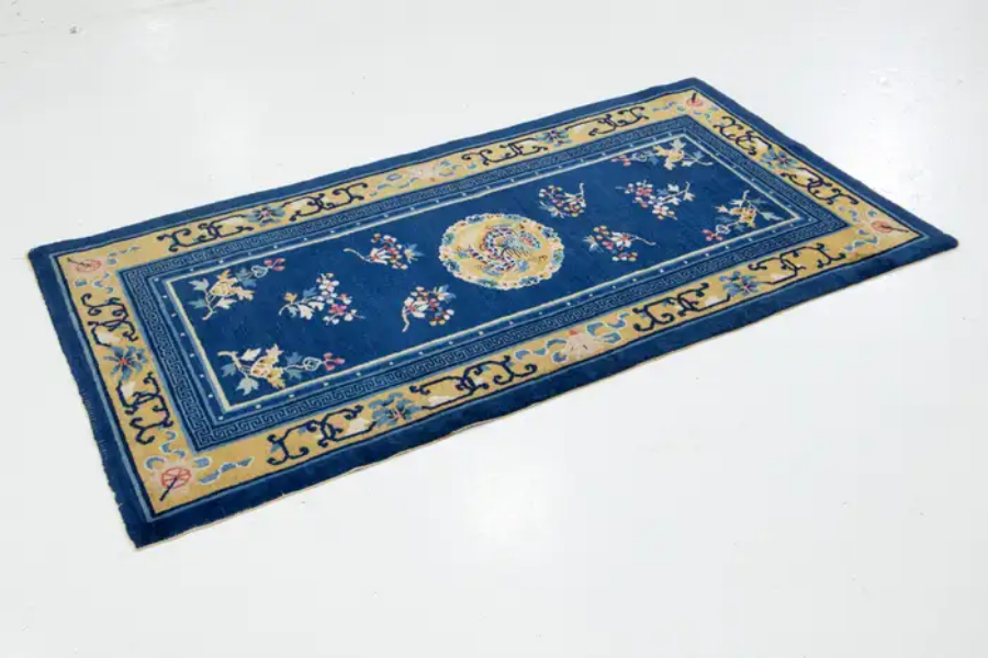 Navy and gold Chinese-style rug with a floral medallion