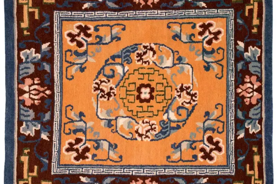 Orange Central Asian rug with a blue and cream medallion