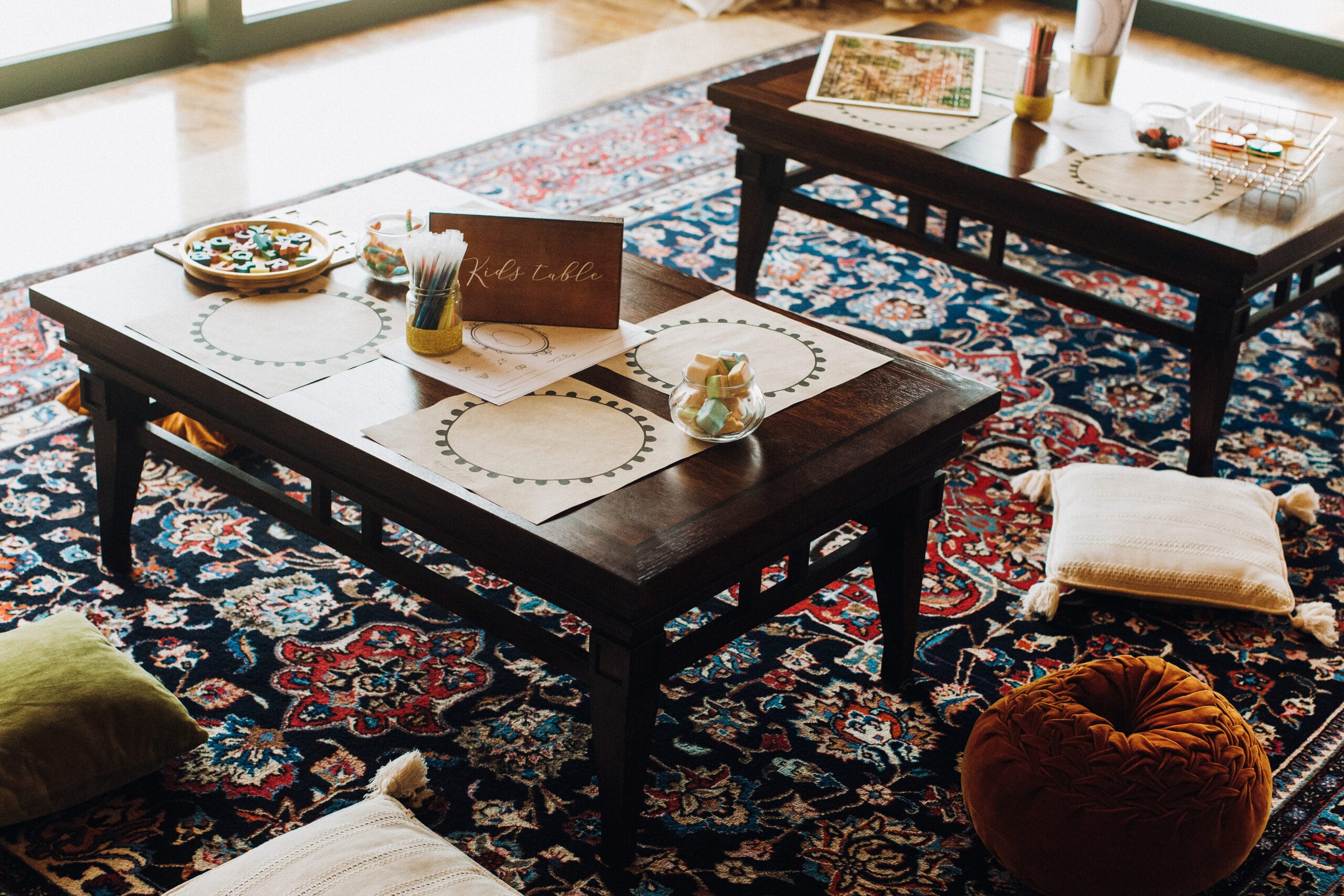 Kids' table set on a blue and red Persian-pattern rug