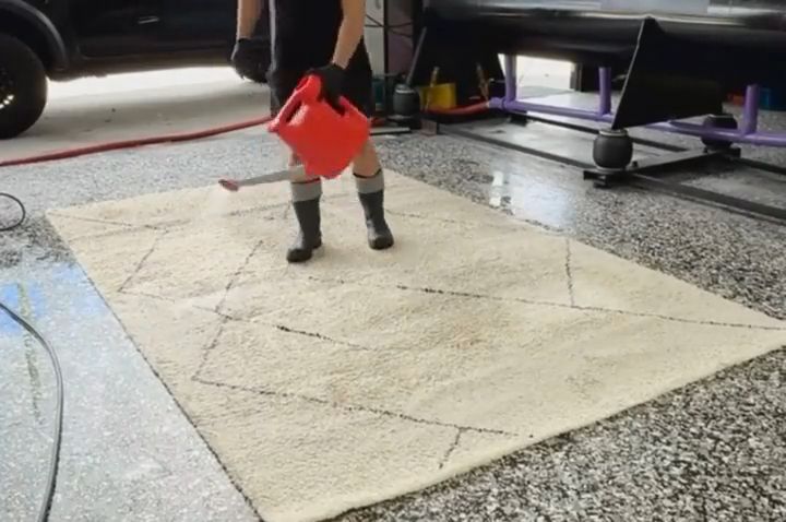 Hand treating a rug on the wash floor at our Yatala facility