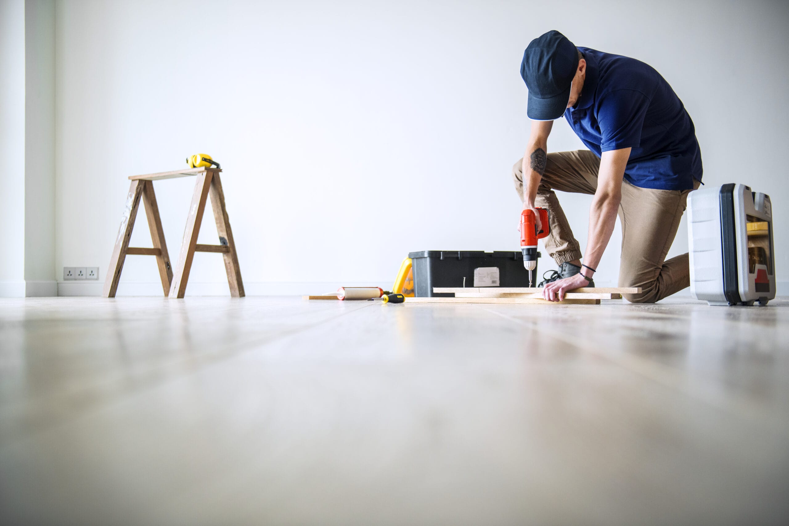 Man drilling wood during a home renovation