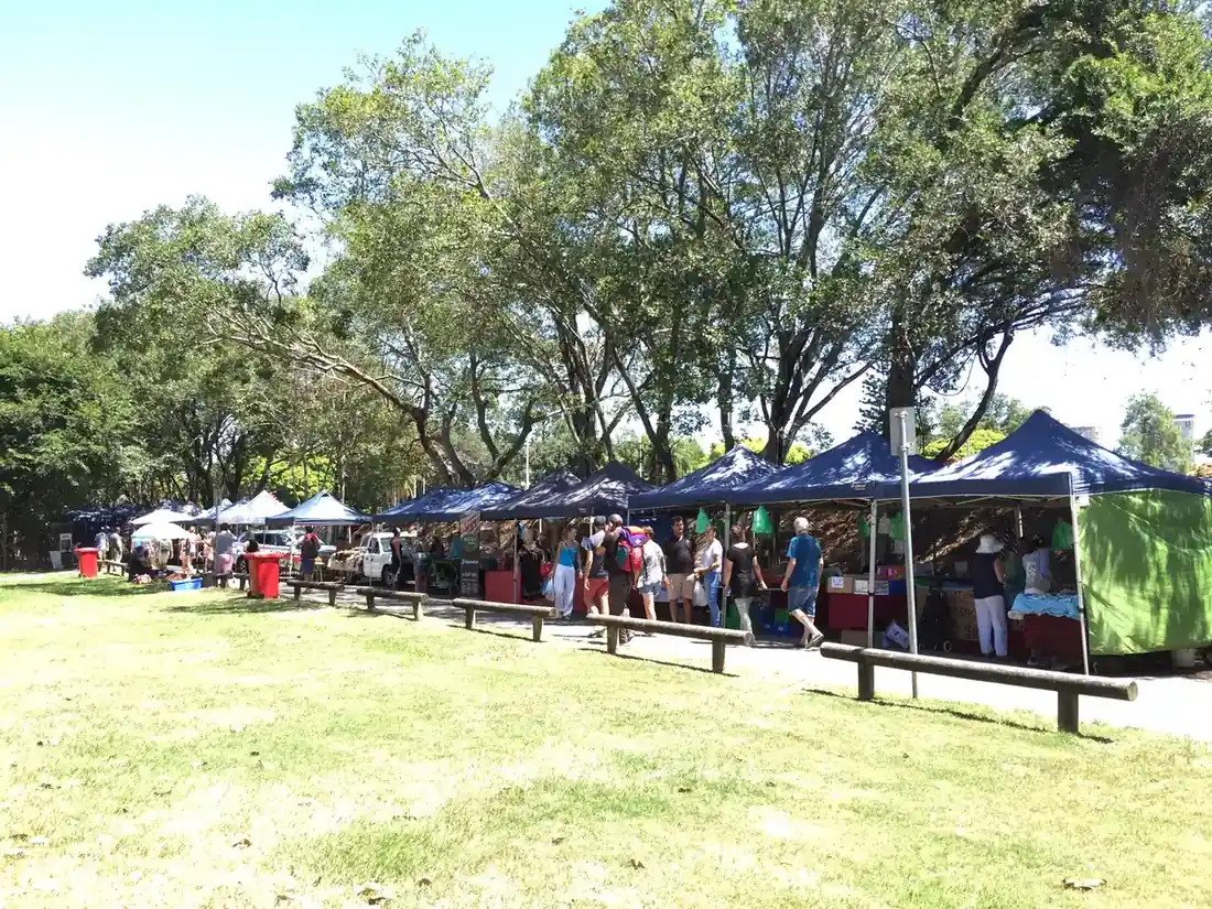 Market stalls under the fig trees at Davies Park, West End