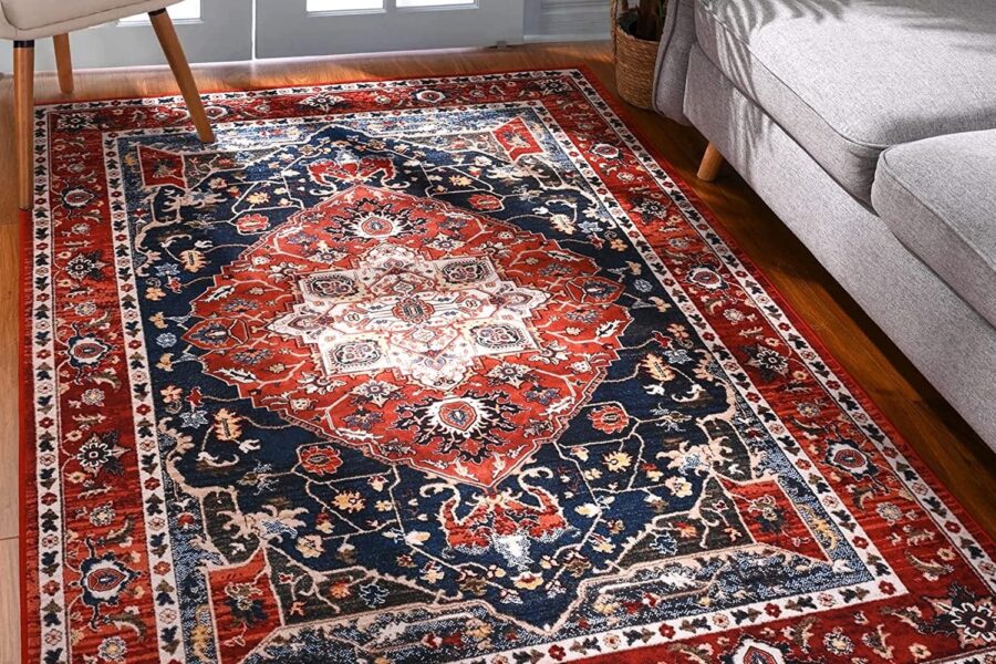 Red and navy medallion-pattern area rug in a living room