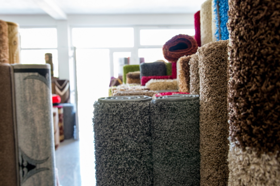 Rolled carpets and rugs stacked in a warehouse
