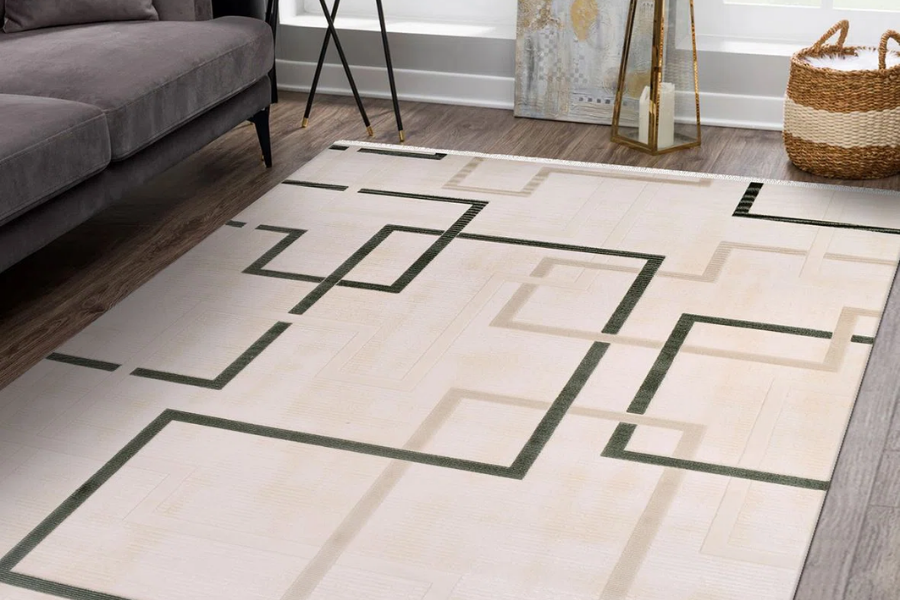 Cream machine-made rug with a green geometric pattern in a living room