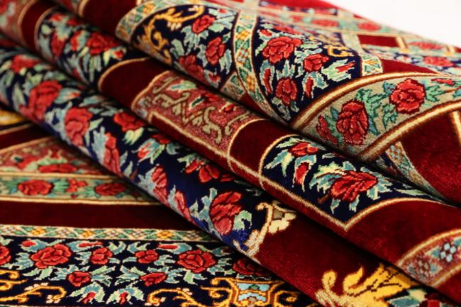 Close-up of a red and navy floral-pattern rug fold